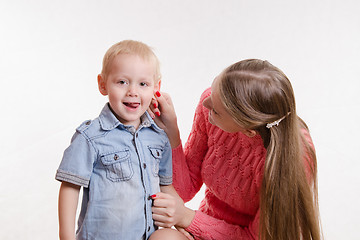 Image showing Mom playfully took his son by the ear