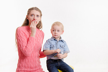 Image showing Young mother is shocked by three sons