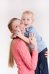 Image showing Mom hugging her son with soap bubbles