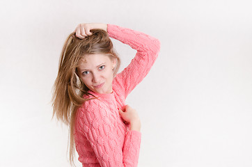 Image showing Cheerful girl picks up a new hairstyle