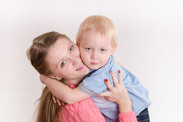 Image showing Young girl hugging her son