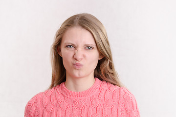 Image showing young girl looks in disgust frame