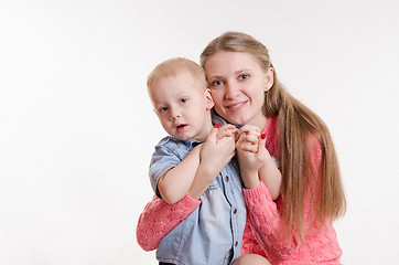 Image showing Mom hugging her son