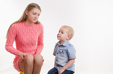 Image showing Young mother reproachfully looks at his young son