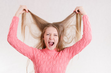 Image showing Girl screams hair raising his hands above him