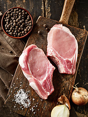 Image showing fresh raw meat on wooden cutting board