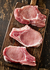 Image showing fresh raw meat on wooden cutting board