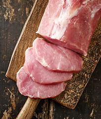 Image showing fresh raw meat on wooden cutting board