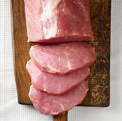 Image showing fresh raw meat on wooden cutting board