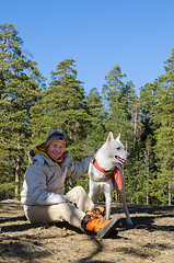 Image showing The woman with a white dog in a wood