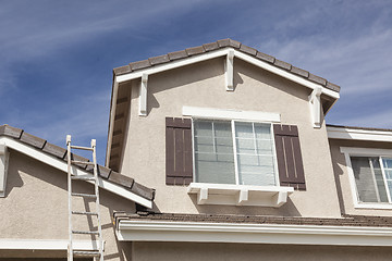 Image showing Ladder Leaning Up Against A Freshly Painted Home