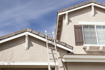 Image showing Ladder Leaning Up Against A Freshly Painted Home