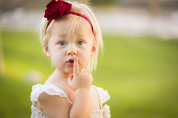 Image showing Adorable Little Girl Wearing White Dress In A Grass Field