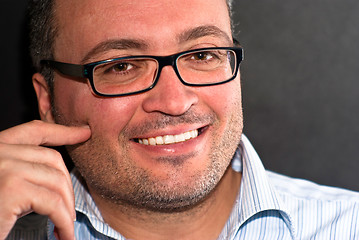 Image showing Smiling bearded caucasian man wearing eyeglasses striped shirt