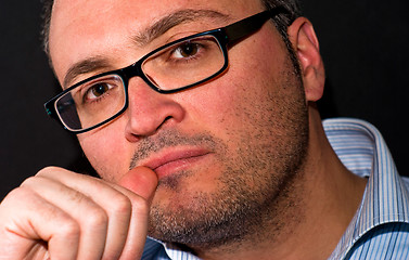 Image showing Pensive bearded caucasian man wearing eyeglasss
