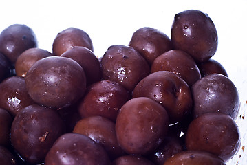 Image showing Brown  olives in bowl isolated 
