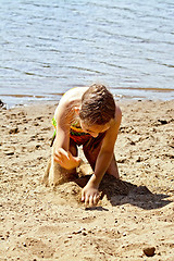 Image showing Girl playing with sand