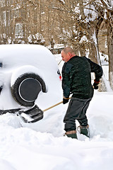 Image showing Man with a shovel in snow