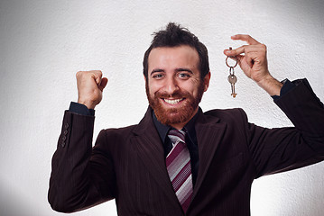 Image showing Happy businessman holding a house key