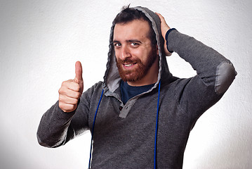 Image showing happy young man showing thumb up sign