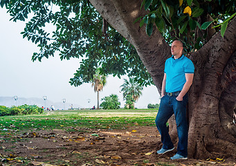 Image showing Man poses outside in the park