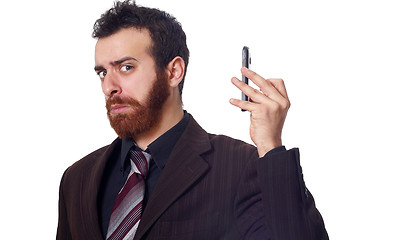Image showing businessman puts his phone away from his ear