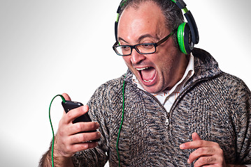 Image showing Man listen music on headphones and scream aloud