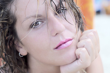 Image showing Beautiful wistful woman looking directly at camera