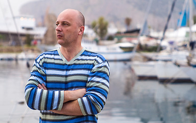 Image showing Businessman standing by expensive sailing boats and yachts in a 
