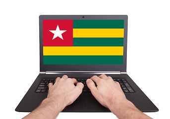 Image showing Hands working on laptop, Togo