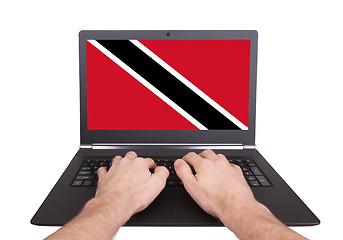 Image showing Hands working on laptop, Trinidad and Tobago