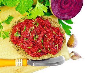 Image showing Sandwich with beet caviar and knife on board