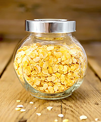 Image showing Pea flakes in jar on board