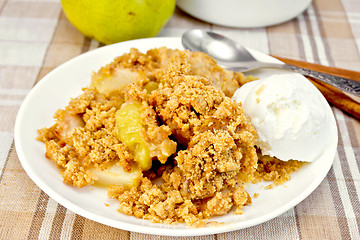 Image showing Crumble with pears in plate on tablecloth