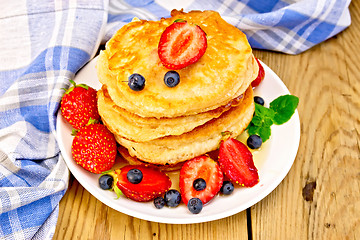 Image showing Flapjacks with strawberries and blueberries on board