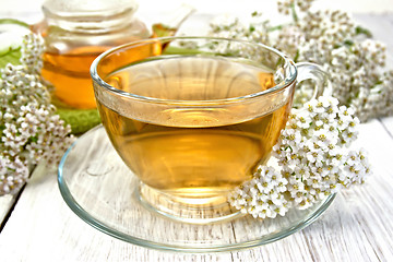 Image showing Tea with yarrow in cup on light board