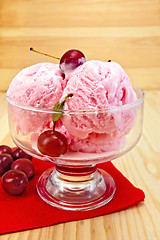 Image showing Ice cream cherry on red napkin and board