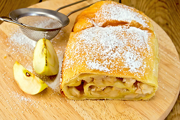 Image showing Strudel apple with strainer on board