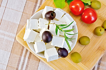 Image showing Feta with olives in bowl on fabric