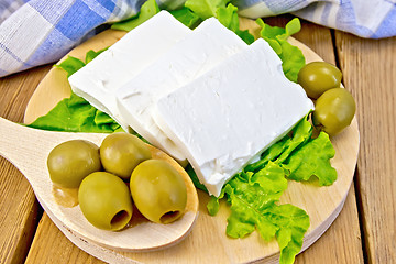 Image showing Feta with olives and lettuce on board and spoon