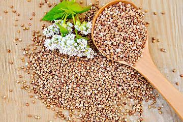 Image showing Buckwheat on board with flower and spoon