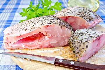 Image showing Bream raw with parsley on fabric