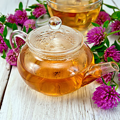 Image showing Tea with clover in glass teapot on board