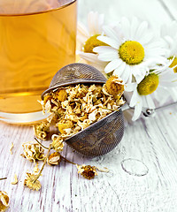 Image showing Chamomile dried in strainer on board