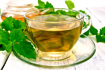 Image showing Tea with melissa in cup on light board