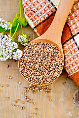 Image showing Buckwheat in spoon on board with flower and doily