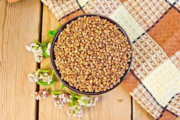 Image showing Buckwheat in bowl with flower on board top