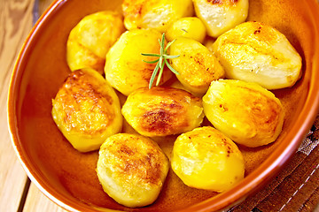 Image showing Potatoes fried in ceramic pan on board