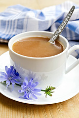 Image showing Chicory drink in white cup with spoon and flower on board