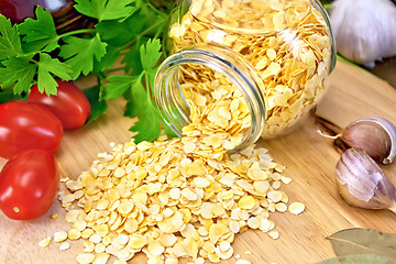 Image showing Pea flakes in jar with garlic on board